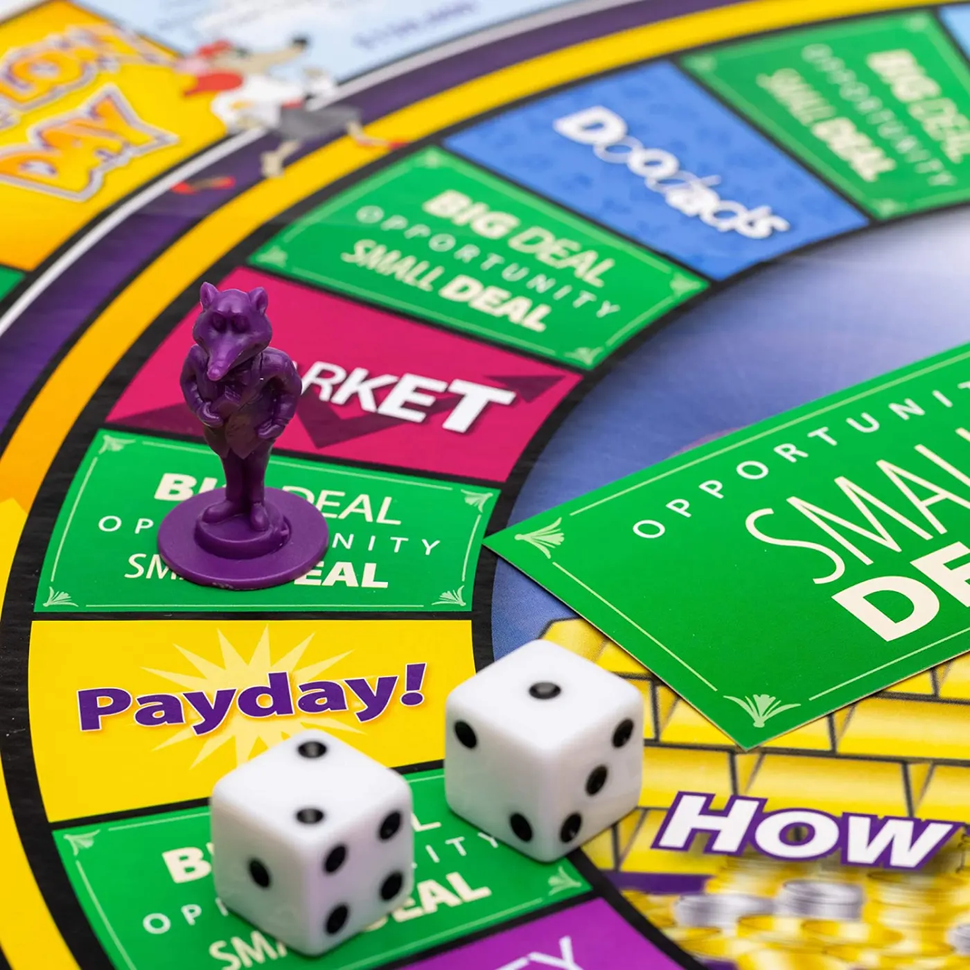 The Cashflow board up close: a purple rat pawn, two dice and the Payday square.